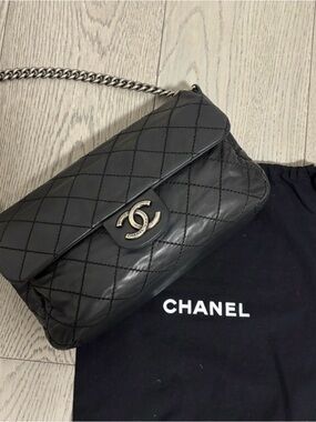 CHANEL Black Quilted Lambskin Flap Bag with Silver Chain